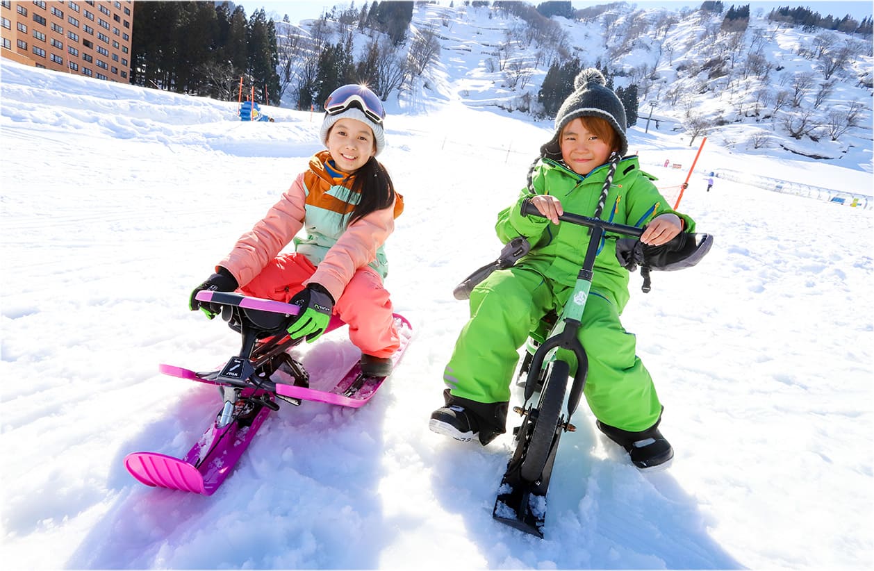 スレッディングコースでそり遊びをする子供たち